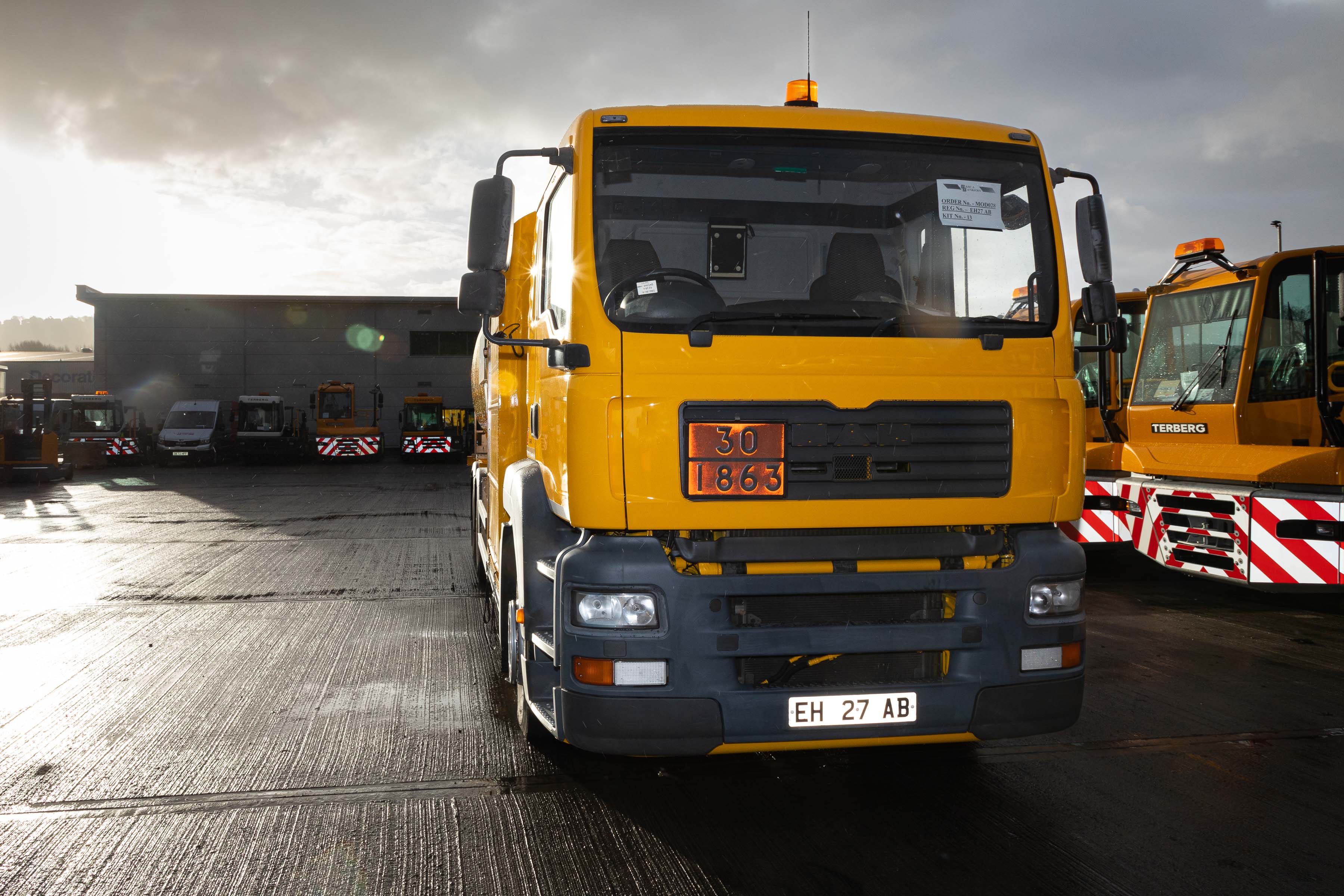 Image shows fuel transport vehicles in car park.